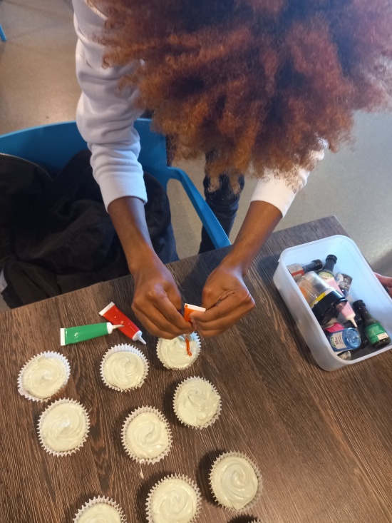 Adding the details to the cupcakes while the shortbread is baking!